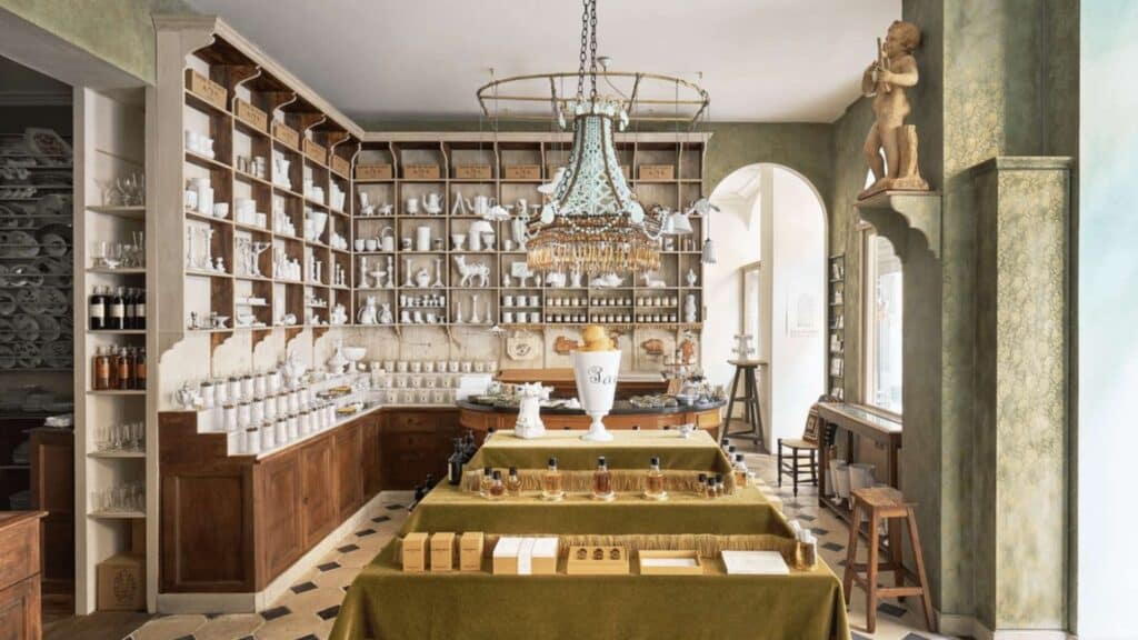 Vintage-style Parisian apothecary with elegant chandeliers, wooden shelves, and classic decor.