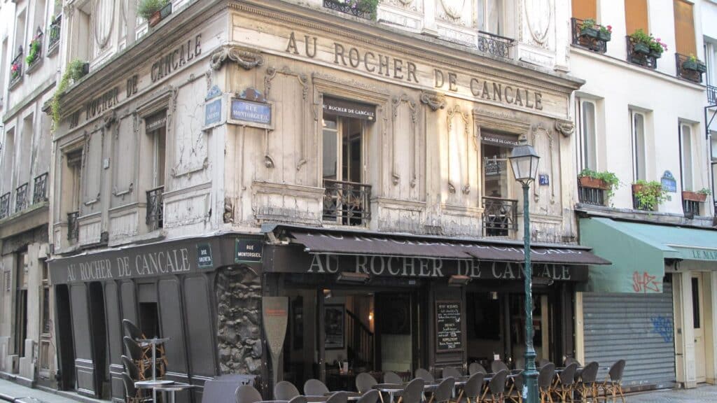 Historic Au Rocher de Cancale restaurant in Paris with classic Parisian architecture and outdoor seating.